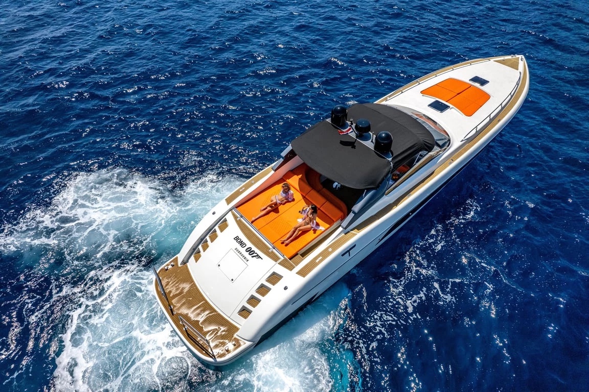Bond 007 from above at speed, showing the orange cockpit seating, black bimini and teak swim platform