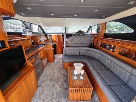 Saloon of the Fairline Phantom 40 — grey leather seating, cherry-wood joinery, galley and helm forward